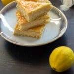 Creamy lemon milk bars layered with puff pastry, cut into squares and dusted with sugar
