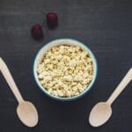 Creamy vegan cottage cheese made with tofu served in a white bowl with a sprinkle of herbs