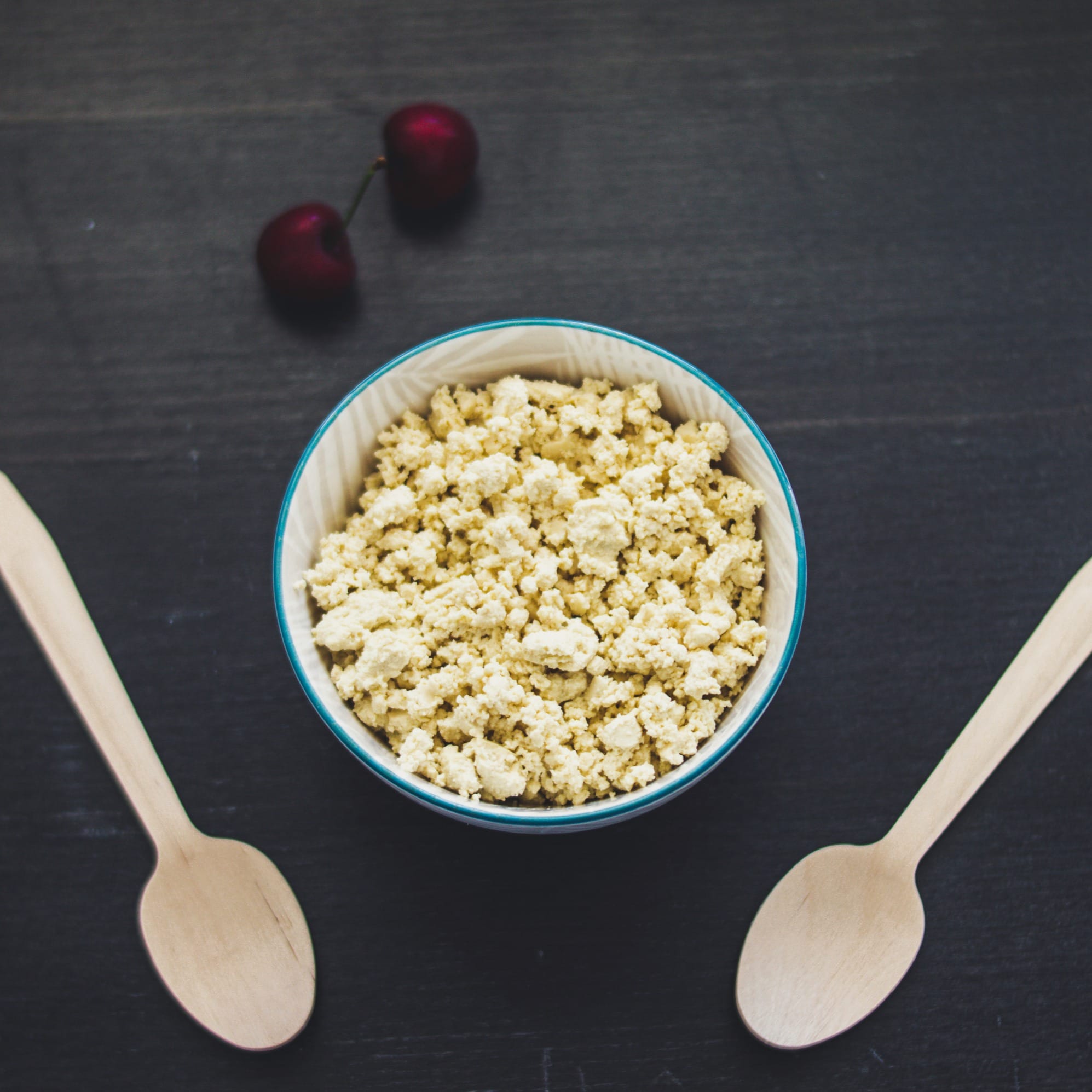 Creamy vegan cottage cheese made with tofu served in a white bowl with a sprinkle of herbs
