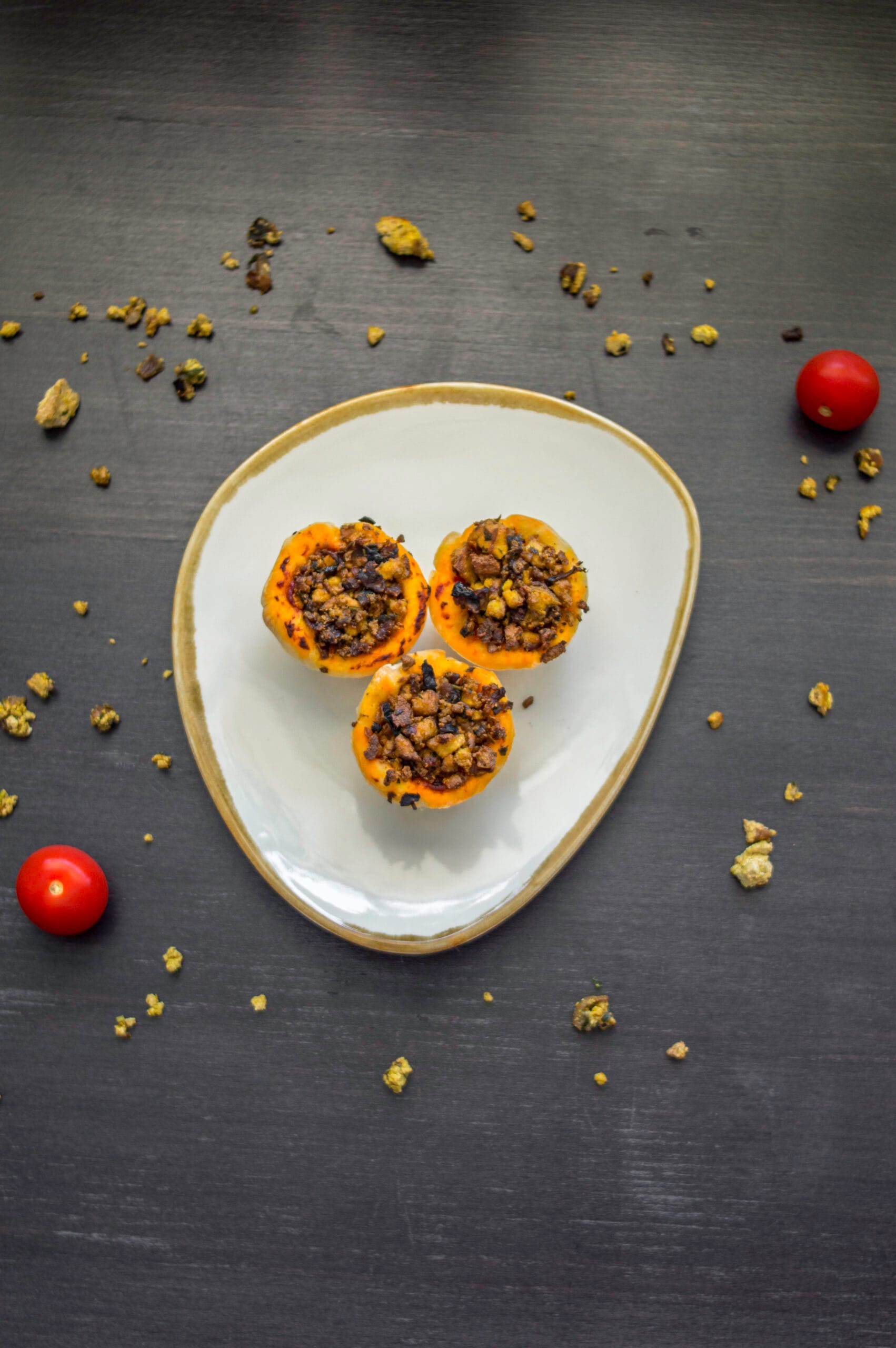 Baked vegan pizza-tofu baskets in muffin tin, topped with herbs and tomato sauce