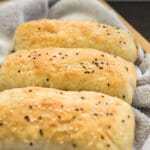 Fluffy vegan hot dog buns arranged on a tray, ready to be filled with carrot dogs or plant-based sausage.