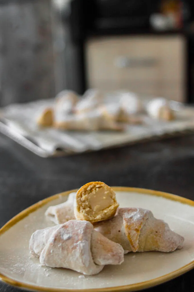 wine croissant cookies on a plate with powdered sugar
