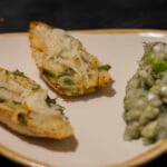 Taco potatoes stuffed with fajita-spiced mash, melted vegan cheese on top, served with a side of creamy avocado salad.