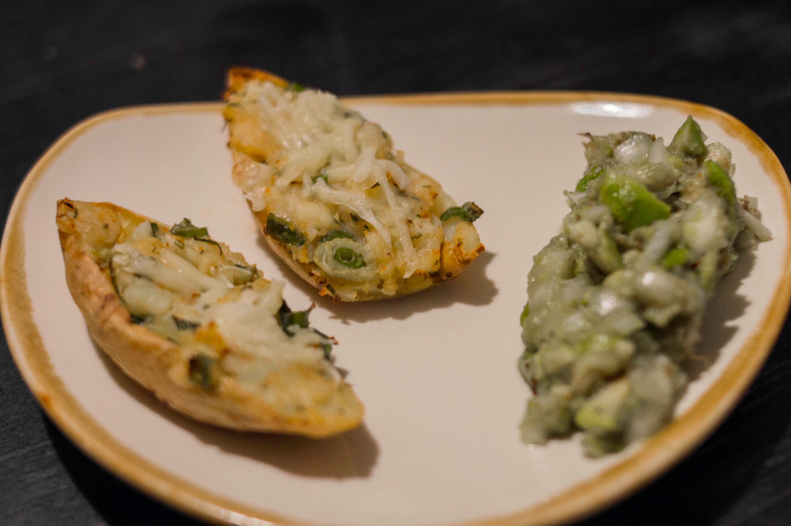 Taco potatoes stuffed with fajita-spiced mash, melted vegan cheese on top, served with a side of creamy avocado salad.